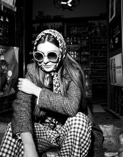 black and white image of a woman from 60s, sitting, fashion wear